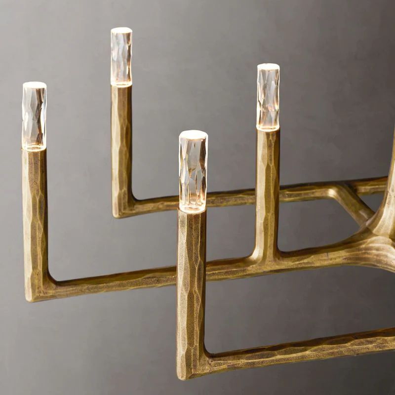 Close-up of matte brass wrought iron frame on Radius rectangular chandelier